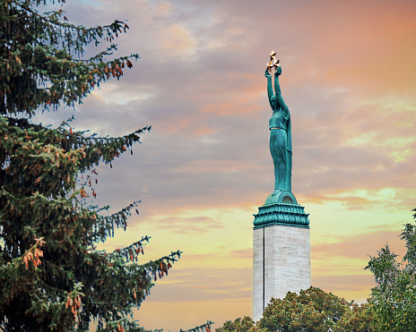 Monument of freedom in Riga. Woman holding three gold stars which symbolise three regions of Latvia.