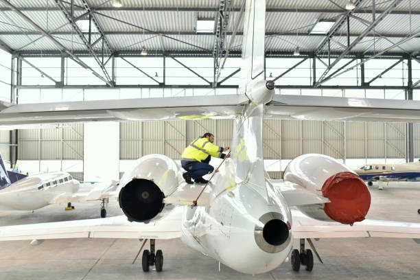istock Airport workers check an aircraft for safety in a hangar 948127614