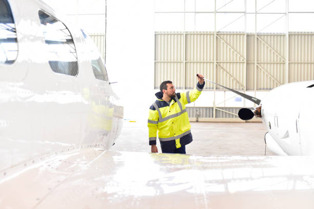 istock Airport workers check an aircraft for safety in a hangar 948128520
