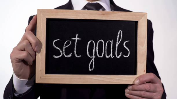 istock Set goals motivation written on blackboard in businessman hands, success tips 948128534
