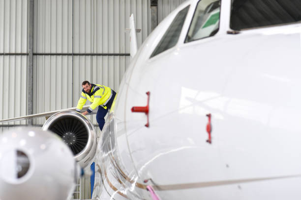 istock Airport workers check an aircraft for safety in a hangar 948128996