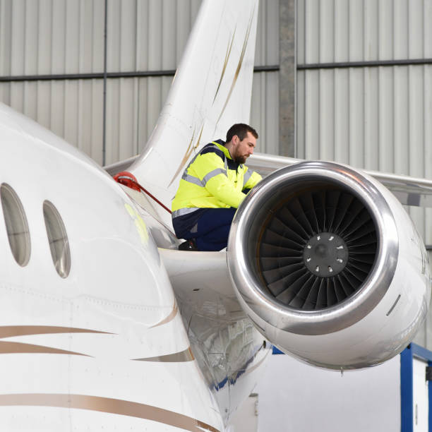istock Airport workers check an aircraft for safety in a hangar 948129096
