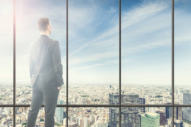 istock Businessman looking at the big city from a skyscraper 948130352
