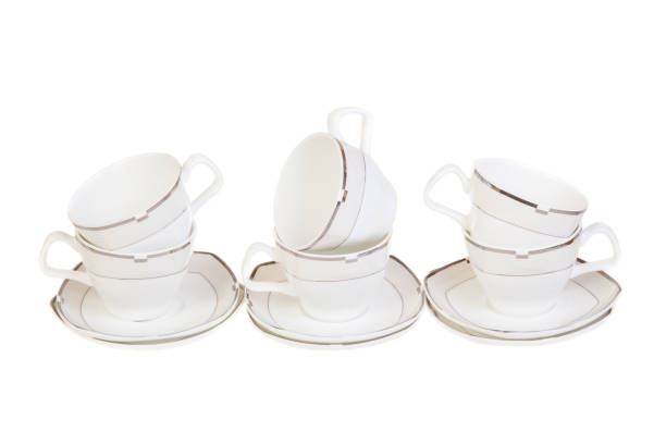 istock Set of six cups for tea or coffee on saucers, isolated on white background. 948135406