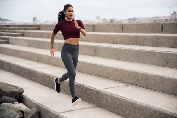 istock Pretty young brunette running along promenade 948136024