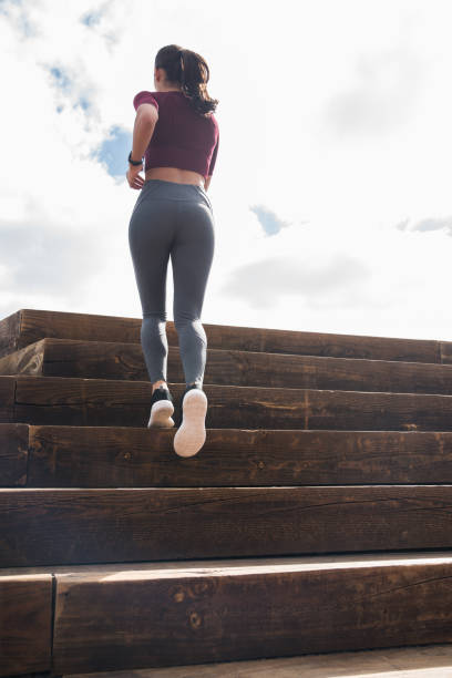 istock Fit young woman running up stairs 948136628
