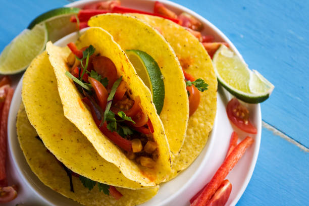 istock Mexican Tacos with Ground Beef and Vegetables on Rustic Blue Background 948142140