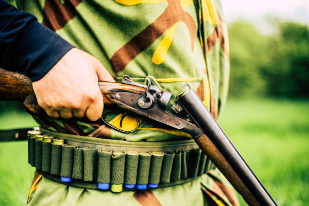 istock Man carrying sniper and cartridge in wilderness 948143642
