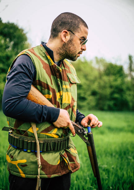 istock Man carrying sniper and cartridge in wilderness 948143688