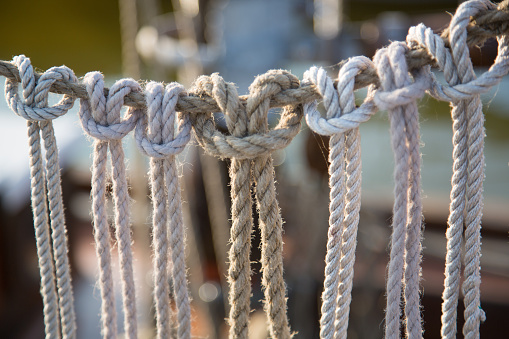 Hanging ropes with knots on a sailing ship