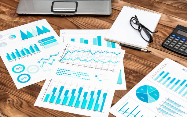 istock Workplace with financial graphs, notepad, calculator and laptop. Businees research. 948158610
