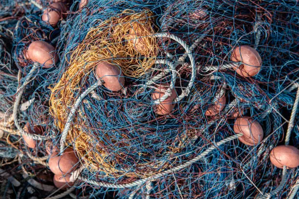 Baskets full of blue fishing catching nets on a fishing boat.