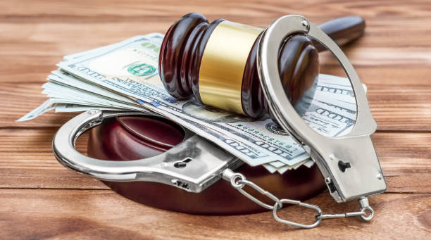 Gavel with handcuffs and money on the wooden table. Crime and law concept. Gavel with handcuffs and money on the wooden table. Crime and law concept. bail bond services stock pictures, royalty-free photos & images
