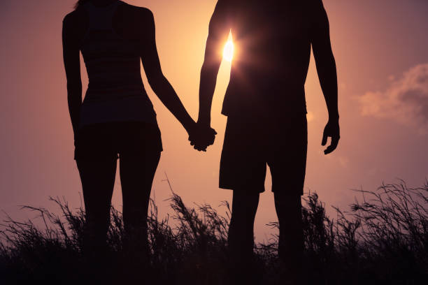 istock Couple holding hands in the sunset. 948164884