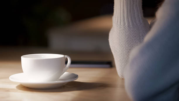 istock White tableware in cafe, woman drinking cup of hot tea at restaurant, relax 948171904