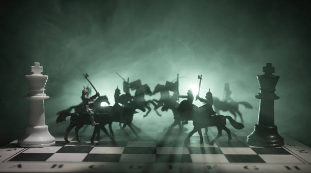istock Medieval battle scene with cavalry and infantry on chessboard. Chess board game concept of business ideas and competition and strategy ideas Chess figures on a dark background. Selective focus 948184140