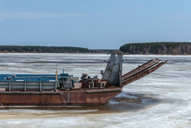 istock Old river ferry on a frozen river 948187812