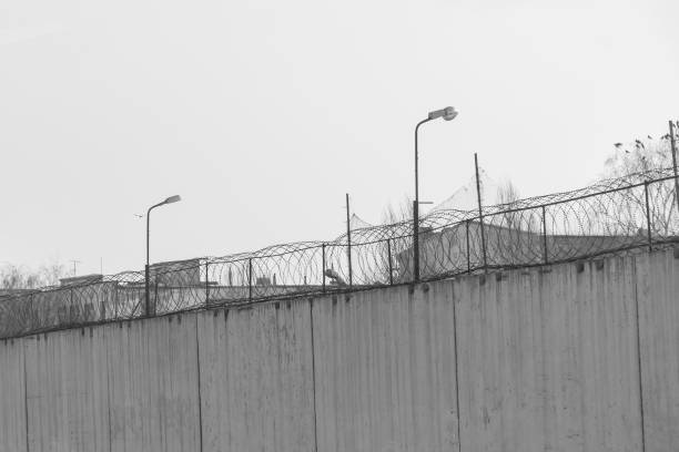 istock Fence with barbed wire, place of detention 948193828