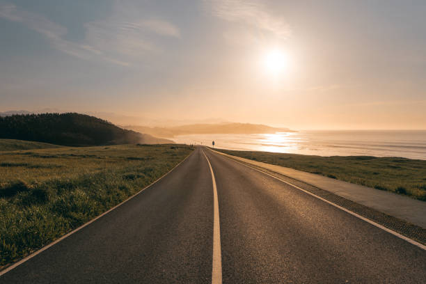istock Road by the sea at sunset 948205102