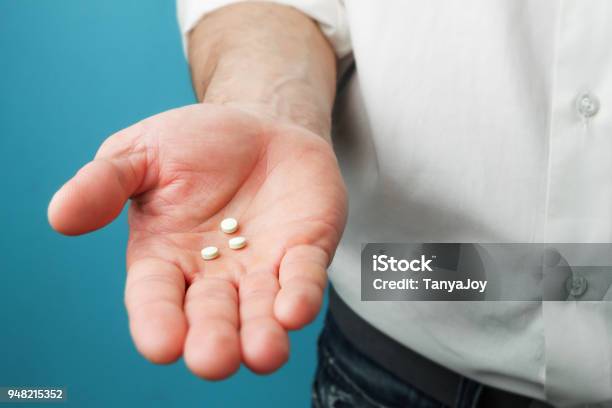 Pills In Hands Of Men Stock Photo - Download Image Now - Men, Birth Control Pill, Contraceptive