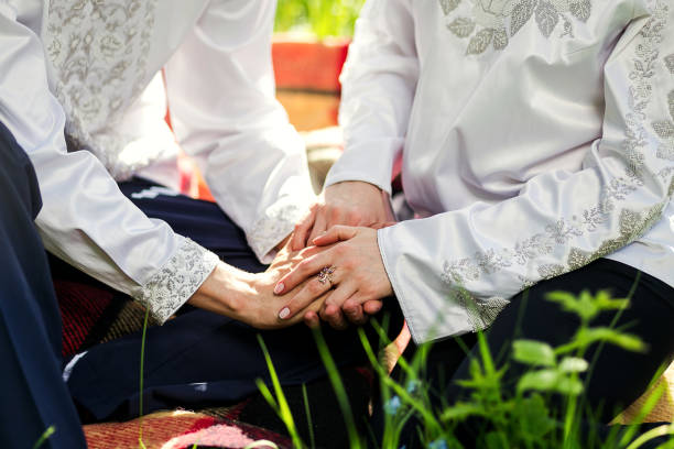 istock couple in love holds hands on nature background 948215902