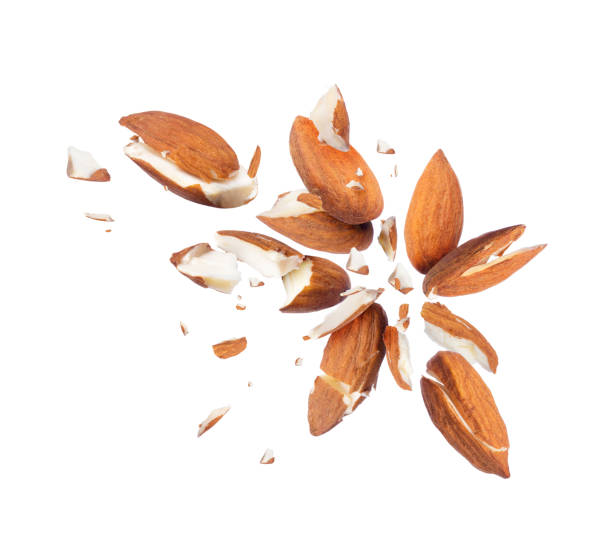 istock Pieces of almonds scattered in different directions on white background 948222990