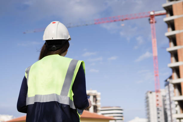 istock Young woman engineer at construction site, rear shot 948230936