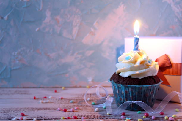 istock Cupcake with birthday candle and gift box. Top view. 948240070
