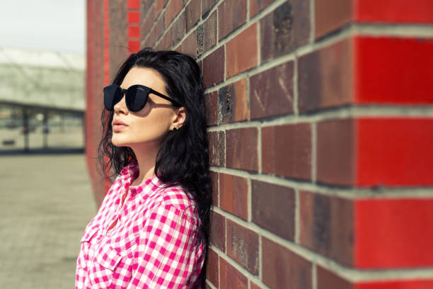 istock A modern look at a thoughtful woman by the wall. 948240210