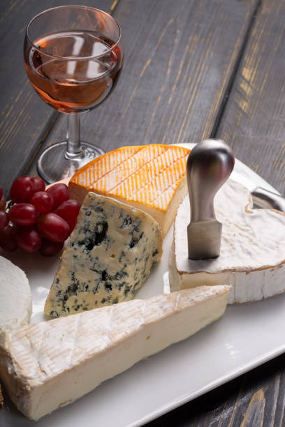 istock French cheeses plate in assortment, blue cheese, brie, munster, soft goat cheese, Neufchatel served with rose wine 948240310