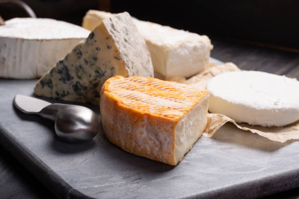 French cheeses plate in assortment, blue cheese, brie, munster, soft goat cheese