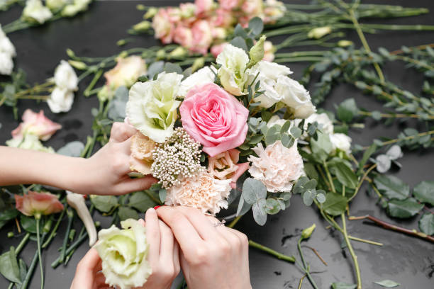 istock Master class on making bouquets for kids. Spring bouquet in metal ornamental flowerpot. Learning flower arranging, making beautiful bouquets with your own hands 948245386