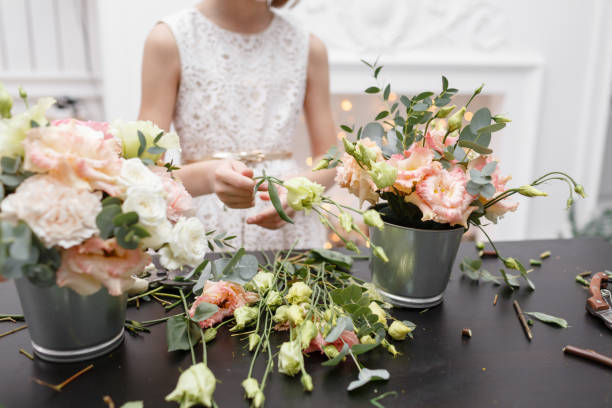 istock Master class on making bouquets for kids. Spring bouquet in metal ornamental flowerpot. Learning flower arranging, making beautiful bouquets with your own hands 948246000