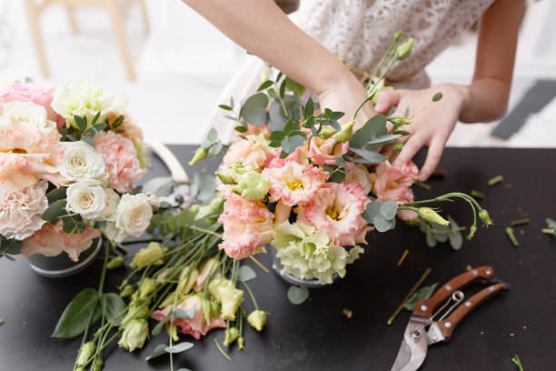 istock Master class on making bouquets for kids. Spring bouquet in metal ornamental flowerpot. Learning flower arranging, making beautiful bouquets with your own hands 948246164