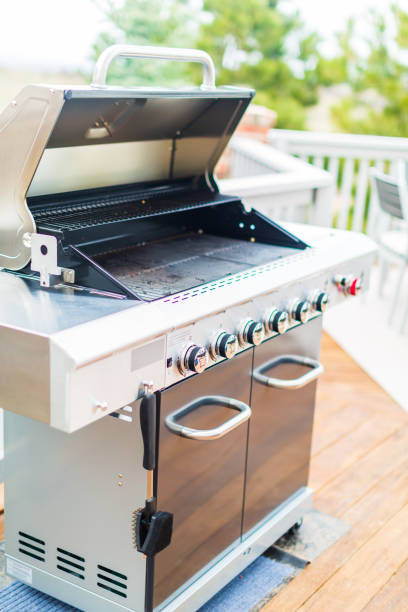 istock Six burner outdoor gas grill with open lid on backyard. 948250478