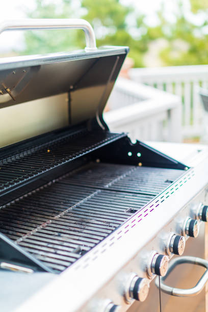 istock Six burner outdoor gas grill with open lid on backyard. 948250486