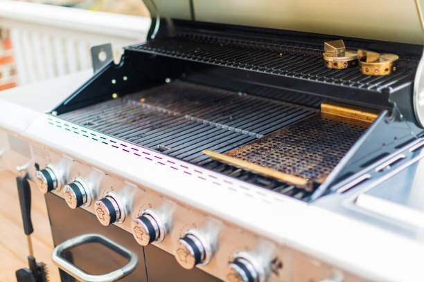 istock Six burner outdoor gas grill with open lid on backyard. 948250500