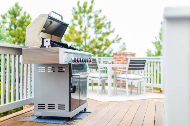 istock Six burner outdoor gas grill with open lid on backyard. 948250644
