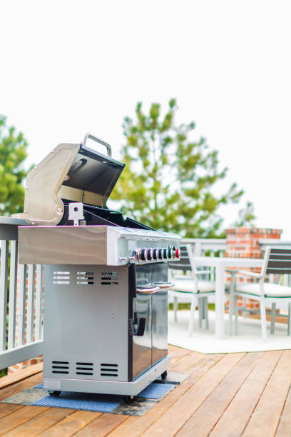 istock Six burner outdoor gas grill with open lid on backyard. 948250646