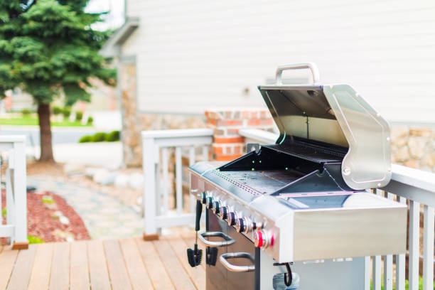 istock Six burner outdoor gas grill with open lid on backyard. 948250746