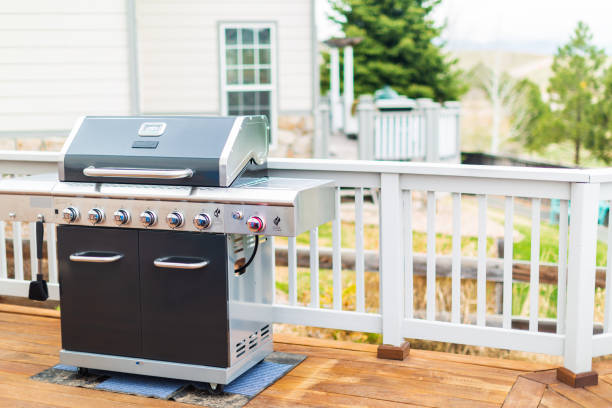 istock Six burner outdoor gas grill with open lid on back patio. 948250848