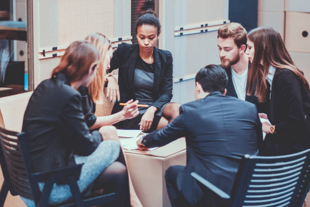 istock Group of creative business people standing behind the desk 948256808