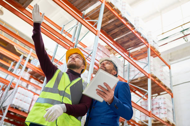 istock Warehouse Worker Taking to Investor 948257006