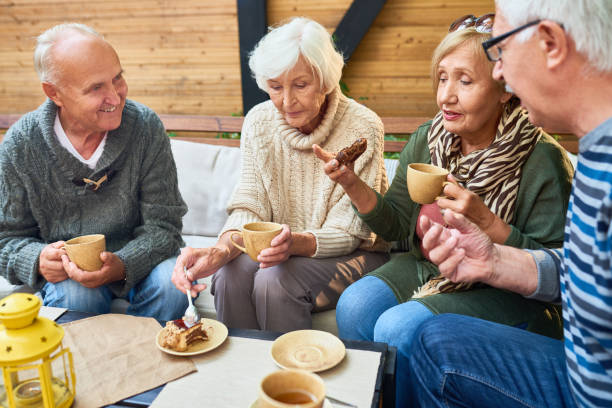 istock Senior Friends Enjoying Tea Time in Cafe 948259852