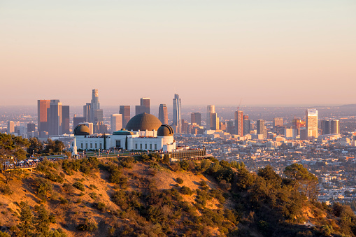 Downtown Los Angeles skyline behind Griffith Observatory at sunset