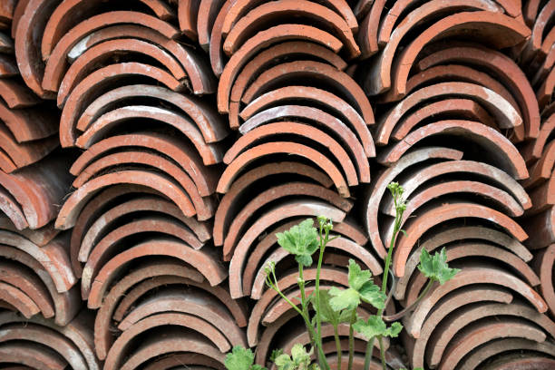 Stack of old clay roof tiles background.