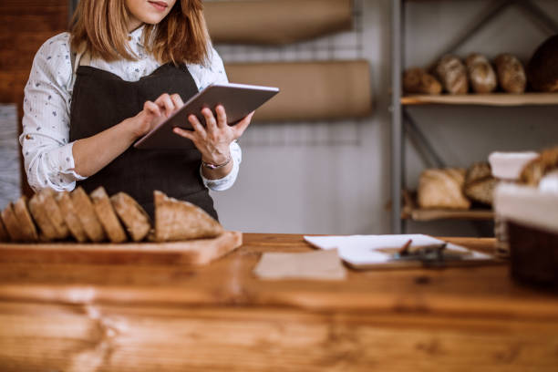 istock Happy Young Woman Standing Confidently In Her Bakery 948286454