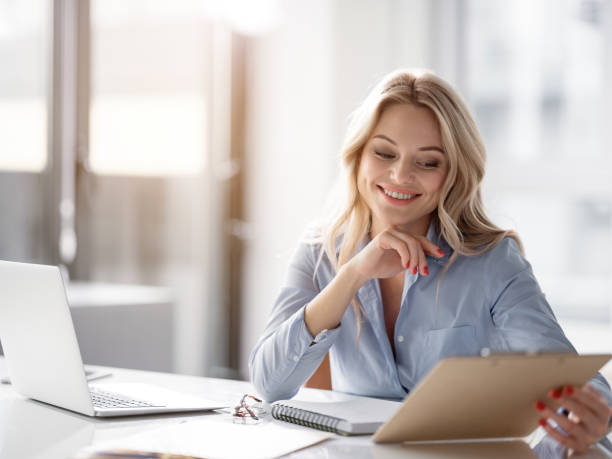 istock Cheerful woman is working in office 948286494
