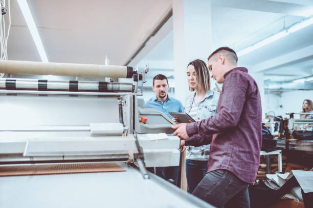 istock Inspector Doing Quality Revision on Material in Textile Factory 948295250