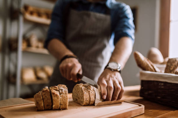 corte las rebanadas de pan delicioso - food industry manufacturing human hand fotografías e imágenes de stock